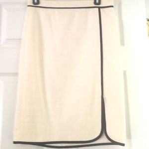 A cotton creme skirt with black outlining.